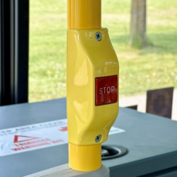 A red stop button on a bus